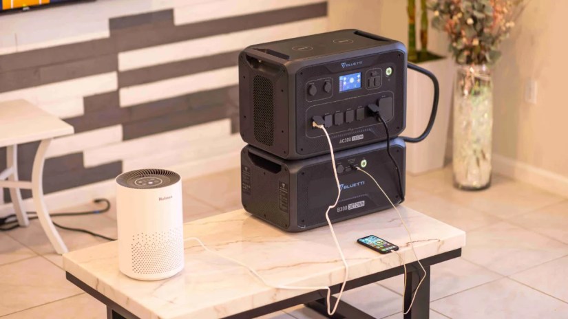 BLUETTI AC300 charging a phone and powering a Bluetooth speaker