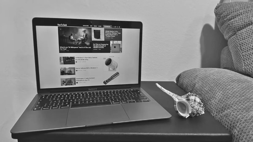 Sydney&rsquo;s M1 MacBook Air on a side table with a seashell.