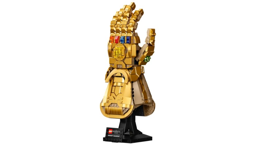 A LEGO model of the Infinity Gauntlet appears on a stand.