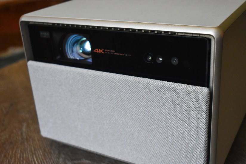 The XGIMI Horizon Ultra on a coffee table with its lens open.
