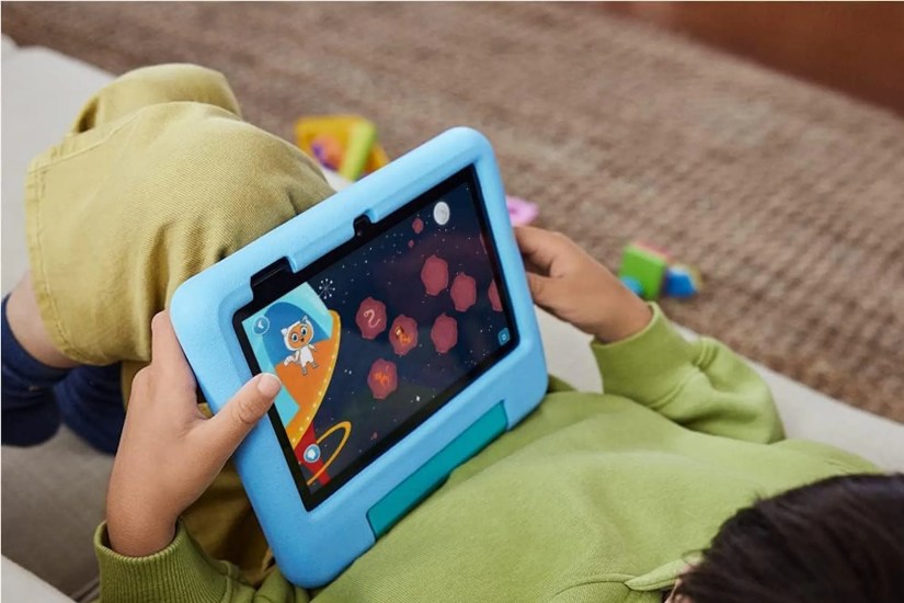amazon fire 7 kids tablet in child&rsquo;s hand laying down