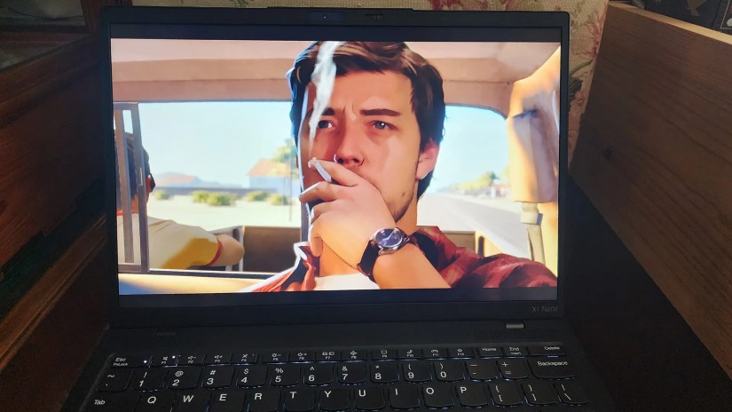 The Lenovo ThinkPad X1 Nano Gen 3 laptop playing a scene with a smoking man from the game &ldquo;As Dusk Falls.&quot;