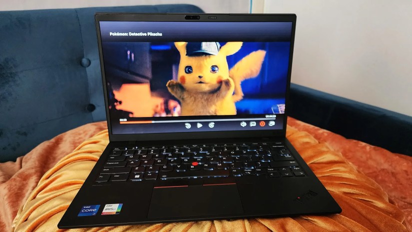 The Lenovo ThinkPad X1 Nano Gen 3 laptop sitting on a bed playing &ldquo;Detective Pikachu.&quot;
