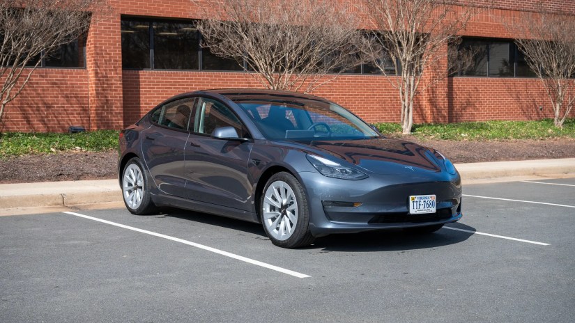 Side view of the Tesla Model 3 in a parking lot.