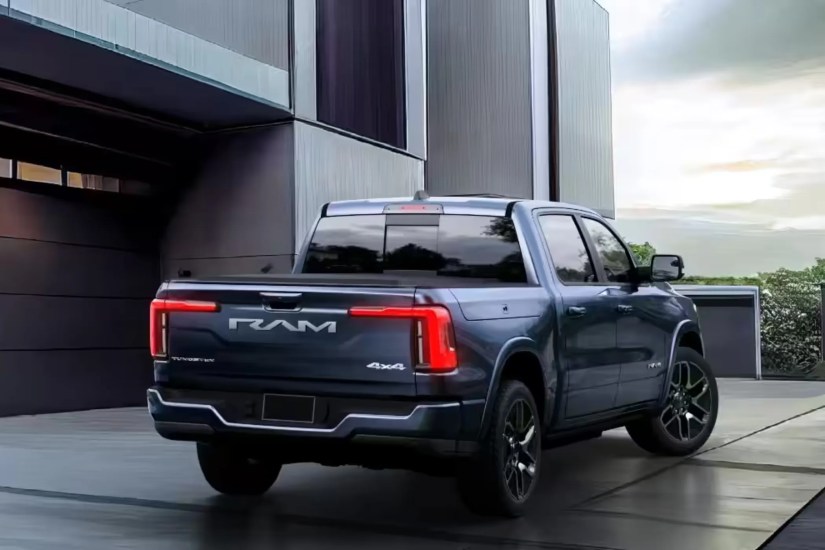 2025 RAM 1500 REV rear end parked in front of a house.