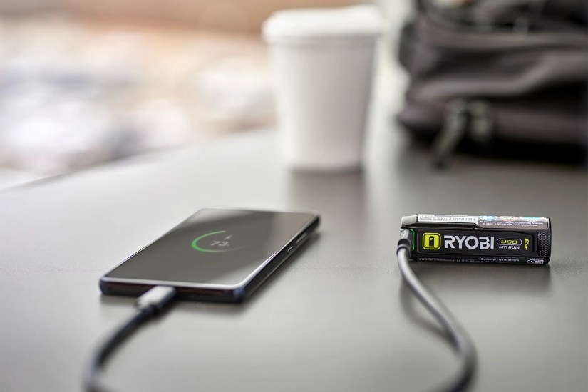 Ryobi USB Lithium battery charging a smartphone.