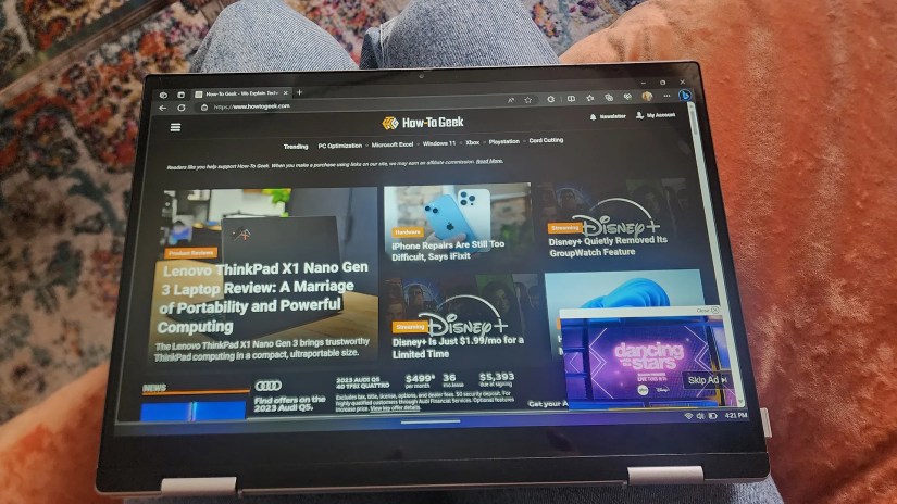 The Dell Inspiron 14 2-in-1 7435 laptop sitting on a person&rsquo;s lap in tablet mode.