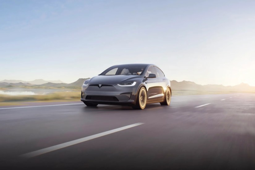 Tesla Model X motion shot driving down a freeway.