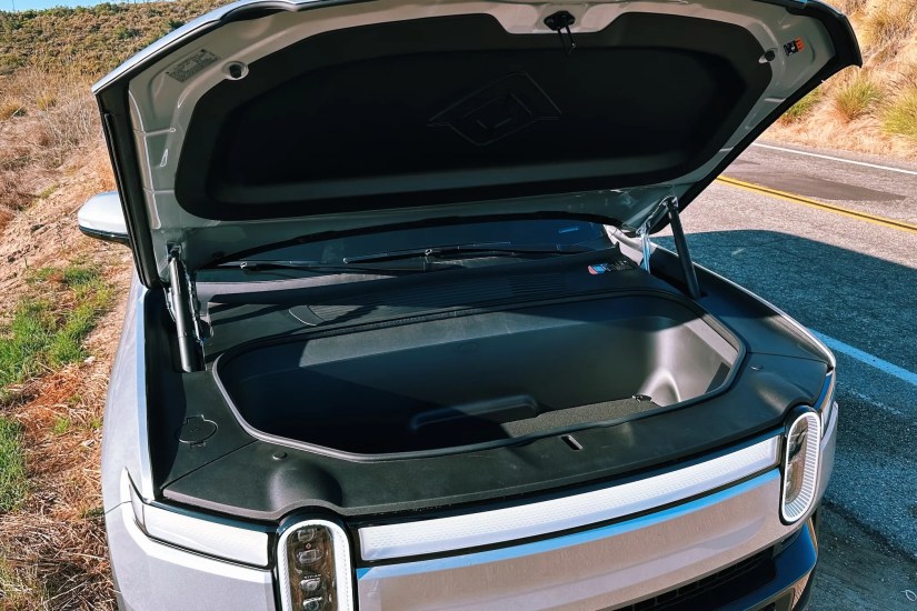 Rivian R1S with open front trunk.