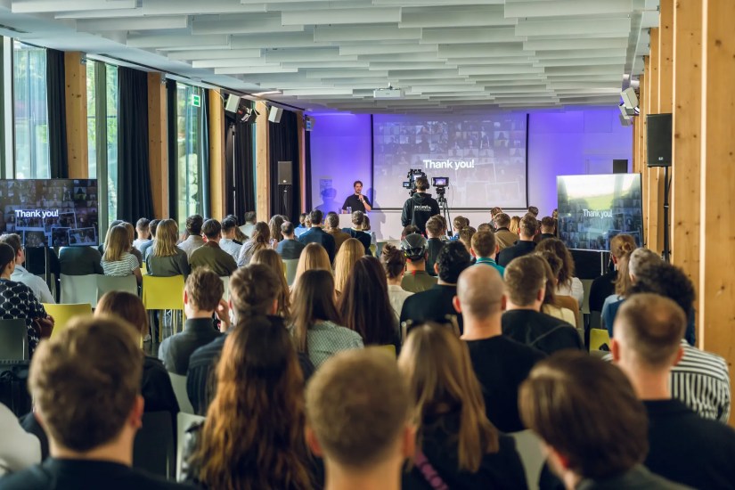crowd of people in front of projector screen