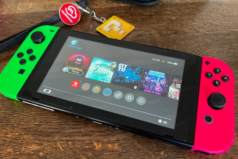 Nintendo Switch console with green and pink JoyCon controllers.