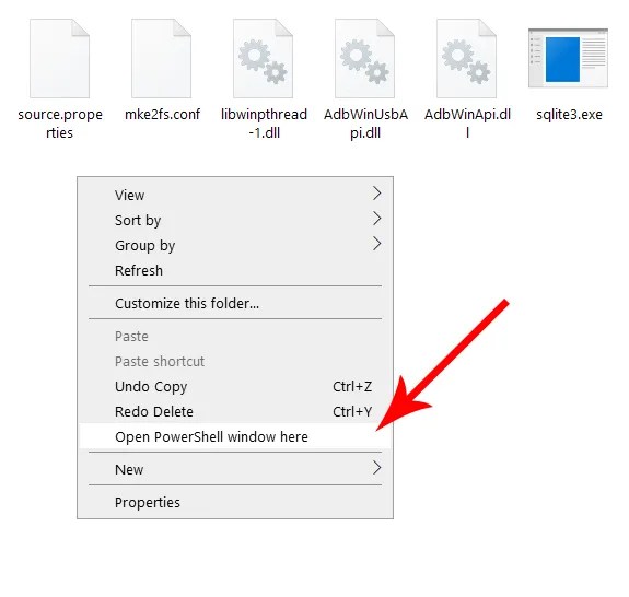 A red arrow pointing at the context menu item for launching Powershell.