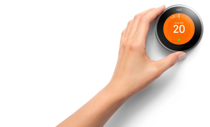 A user turning the Google Nest Learning Thermostat ring.