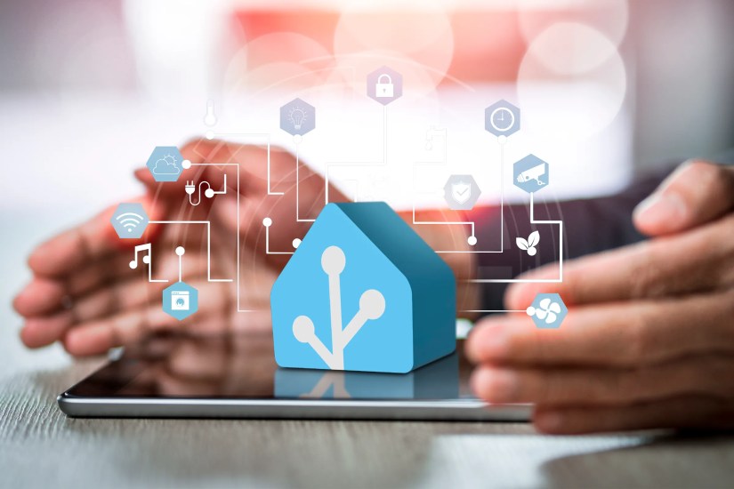 Home Assistant 3D icon on a tablet with a man&rsquo;s hand and icons of home electronics devices connecting with wireless.