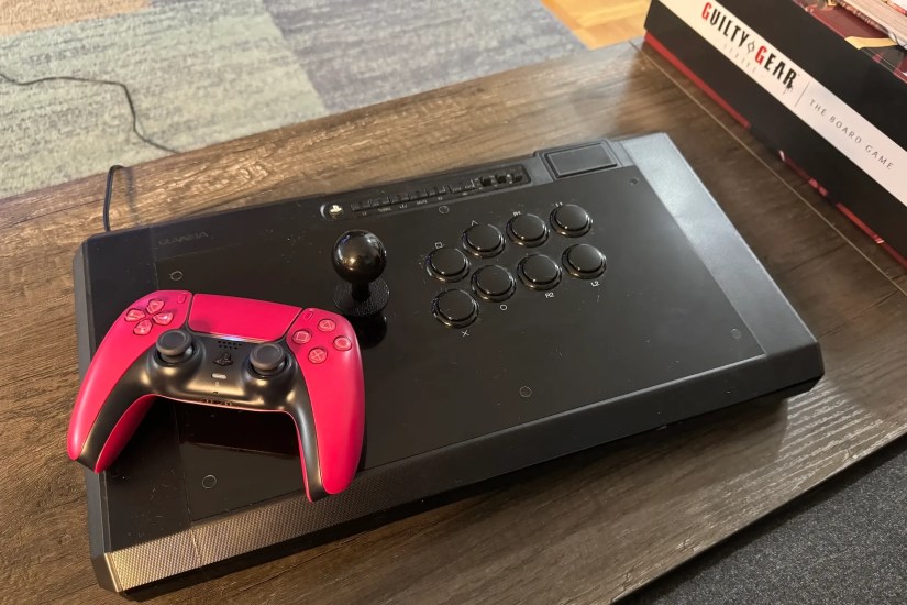 A PS5 DualSense controller on a fight stick.