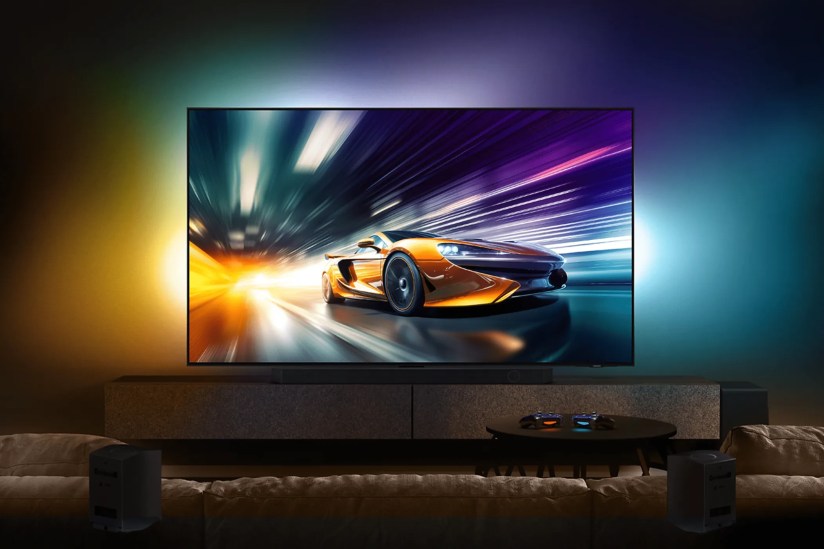 The Samsung QN90D 01 in a room showing racing content.