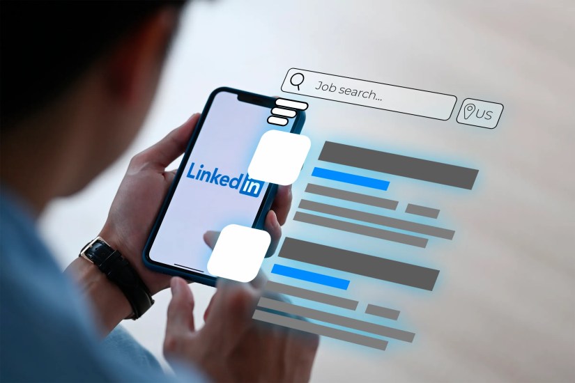 A person holding a phone with the LinkedIn logo and a job search above the screen.
