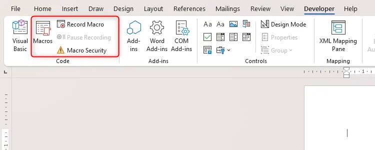 A Word document with the Macros options highlighted in the Developer tab.