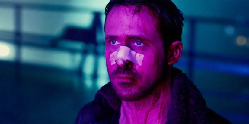 Scene from Blade Runner 2049 showing the main character&rsquo;s face bathed in purple light.