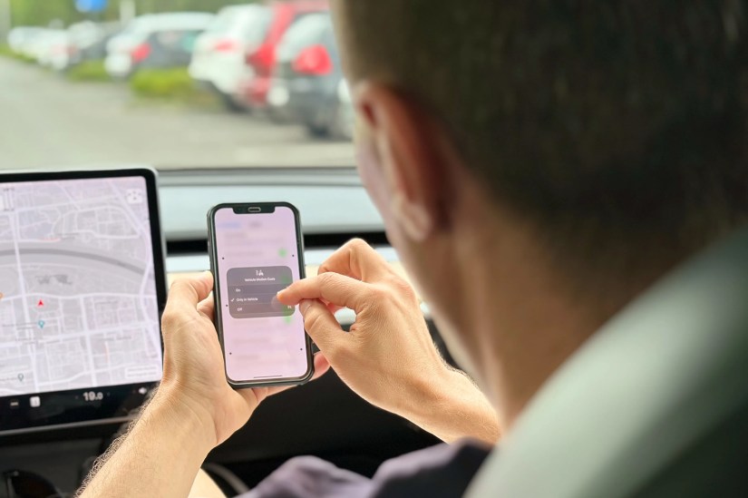 A Tesla passenger enabling Vehicle Motion Cues in their iPhone&rsquo;s Control Center.