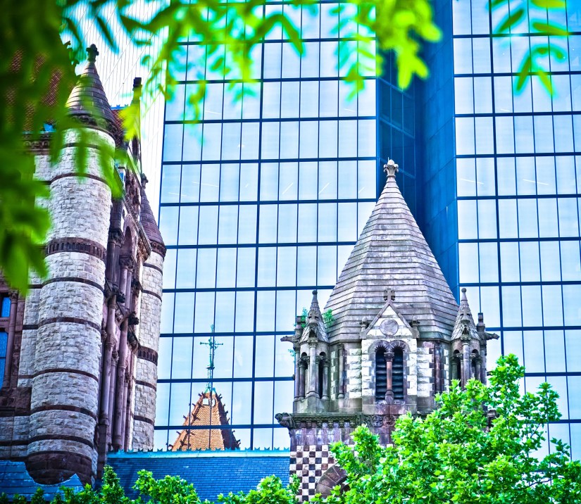 An old church in front of a modern skyscraper in Boston