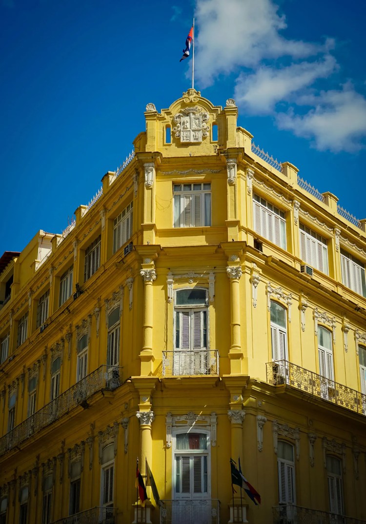 A yellow building in Havana, upper-right section brightly sunlit, the rest in shadow