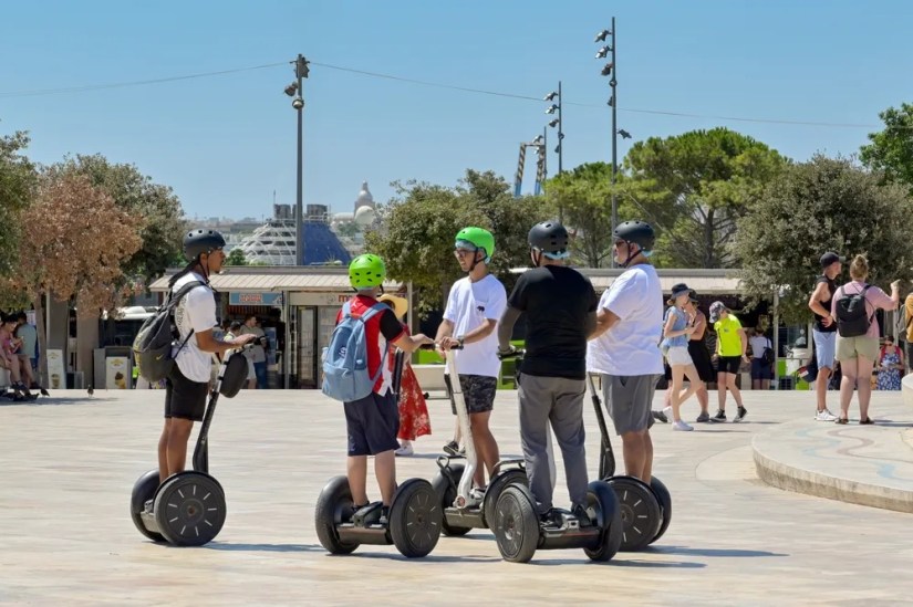 People riding Segways.