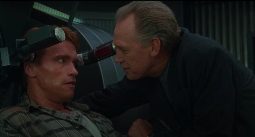 A scene from Total Recall where Quaid is forced into the memory implant machine against his will.