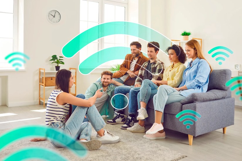 Several people in a living room with multiple wifi icons around.
