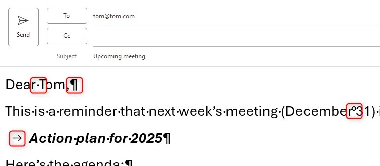 A draft email in classic Outlook, with the non-printing characters displayed and highlighted.