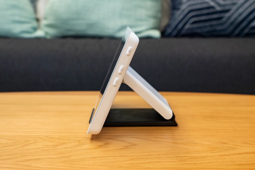 A smart home control panel on a coffee table.