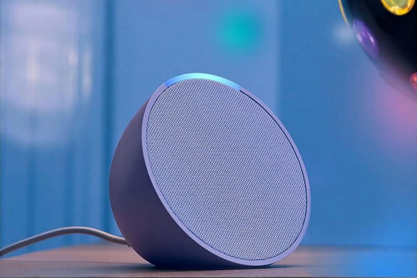 An Amazon Echo Dot with Disco Light in the background.
