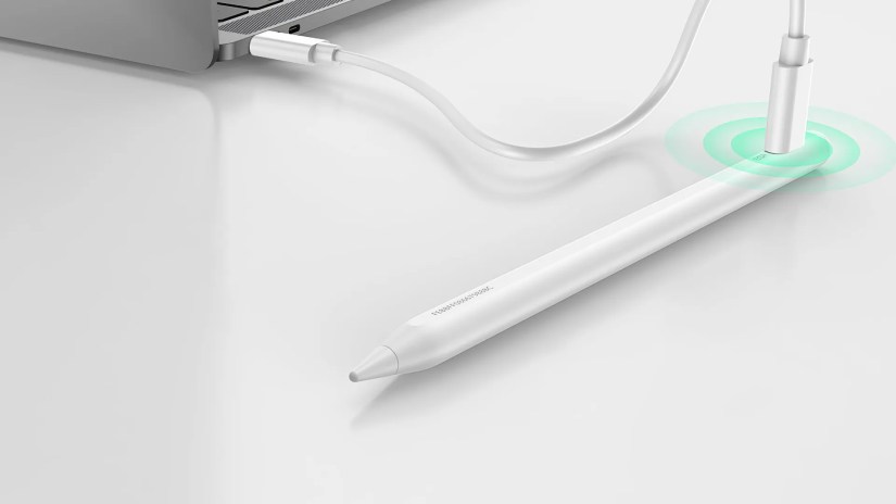 ESR&rsquo;s stylus next to a computer, charging via a USB-C cable.