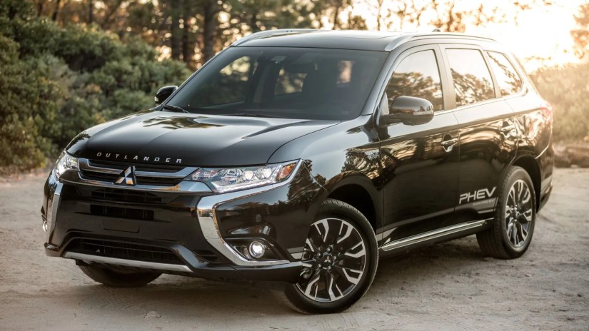 Full view of black 2018 Mitsubishi Outlander Phev parked on gravel.