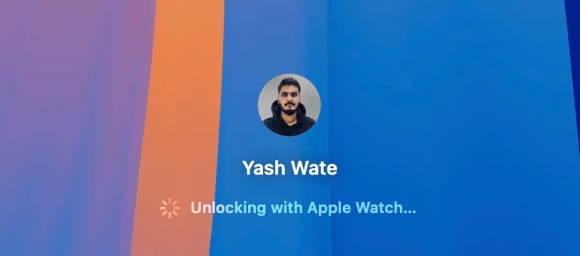 Unlocking with Apple Watch text on macOS Lock Screen when unlocking it using Auto Unlock.