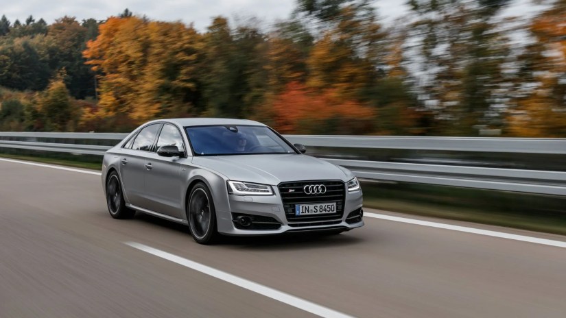 Full view of a silver 2015 Audi S8 Plus driving on a highway.