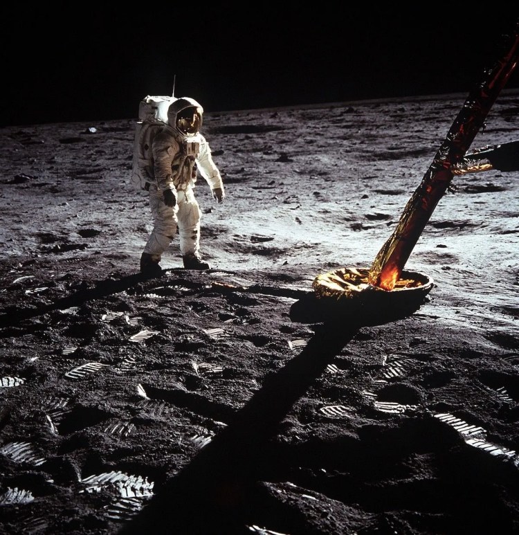 Buzz Aldrin standing on the lunar surface.