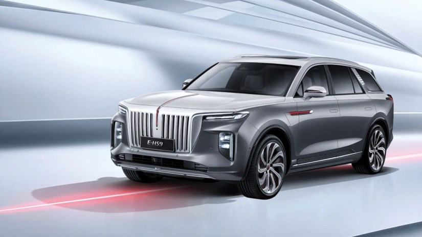 Front 3/4 view of a gray Hongqi E-HS9 in a studio.