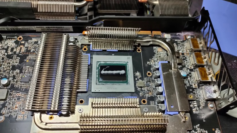 A disassembled AMD RX 6800 XT with new thermal paste on the GPU.