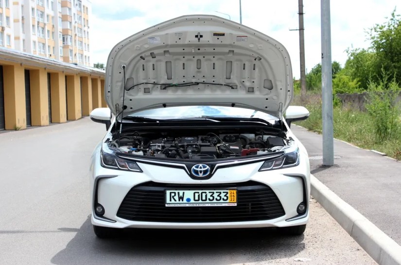 oyota Corolla with open hood.