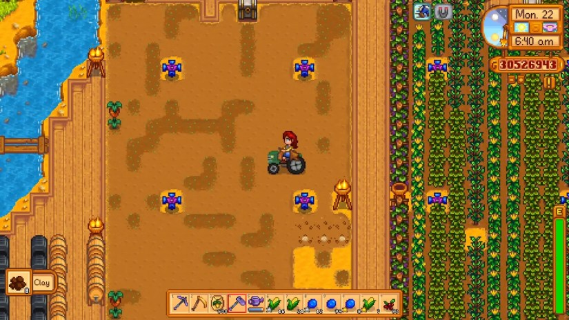 A player rides a tractor through their Ginger Island farm in Stardew Valley.