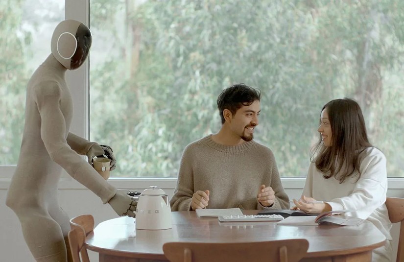 The NEO Gamma robot serving people at a table.