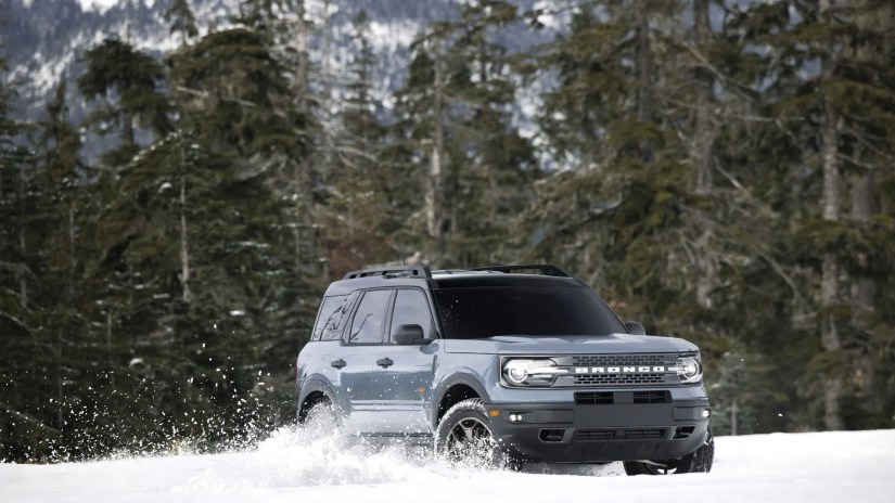Front 3/4 view of a gray 2022 Ford Bronco Sport off-roading in the snow.