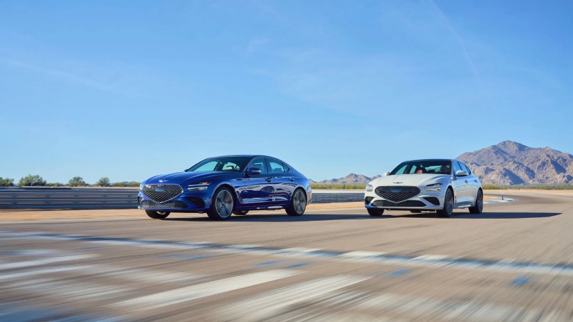Front 3/4 shot of a blue and gray 2025 Genesis G70 racing on a dragstrip.