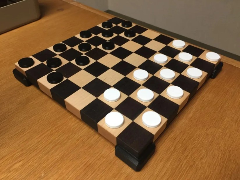 A 3D printed checkers board and checkers pieces.