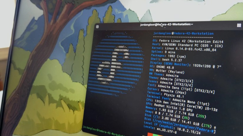 A laptop screen showing Fedora Linux 42 with a terminal open.
