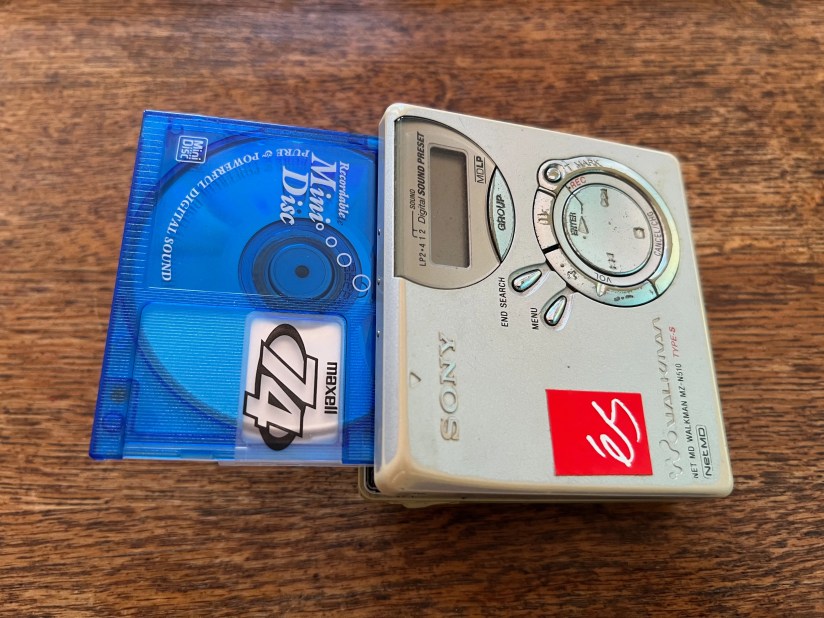 A MiniDisc hanging out of a player.