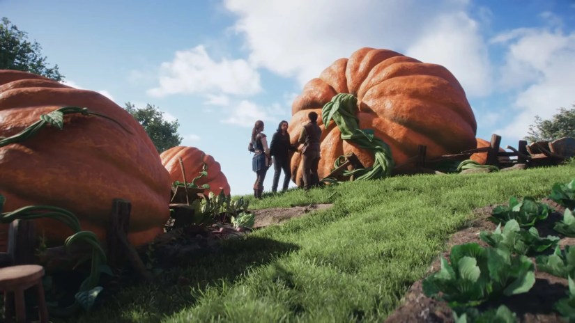The Fable hero and two other characters standing beside giant pumpkins.