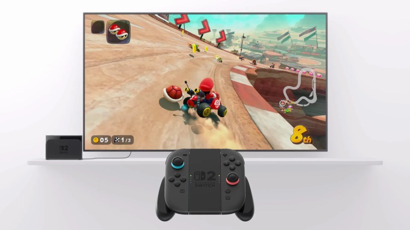 The Nintendo Switch 2, with Mario Kart on a TV and a Joy Cons 2 grip.