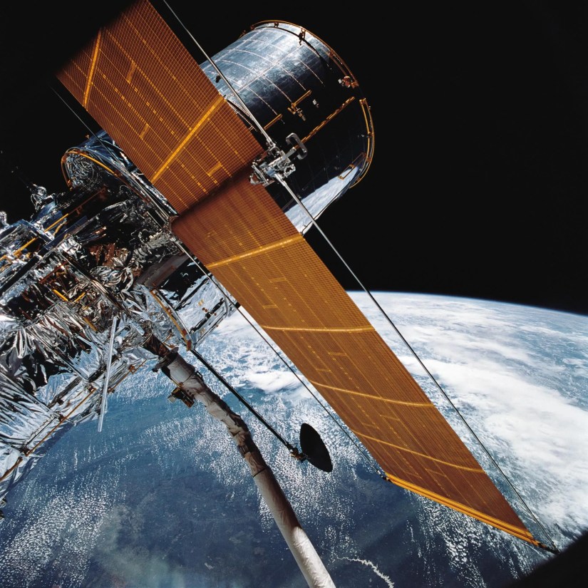 Hubble being manipulated using Canadarm.